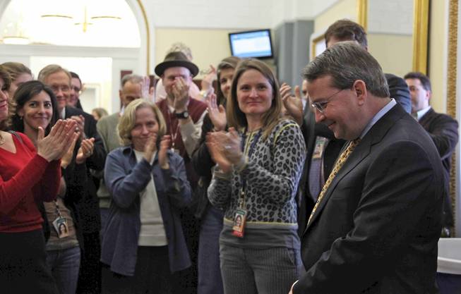 Members of the Capitol Hill press corps and Sen. Harry Reid applaud Reid's outgoing communications director Jim Manley upon his departure from Capitol Hill during a get-together in the Senate Press Gallery in the Capitol on Friday afternoon.