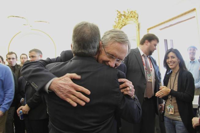 Sen. Harry Reid gives his outgoing communications director Jim Manley a hug in the Senate Press Gallery in the Capitol on Friday afternoon.