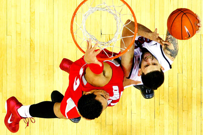 UNLV's Carlos Lopez is defended by New Mexico forward Drew Gordon during their game Saturday, January 22, 2011 at the Thomas & Mack Center. UNLV pulled out a 63-62 win.