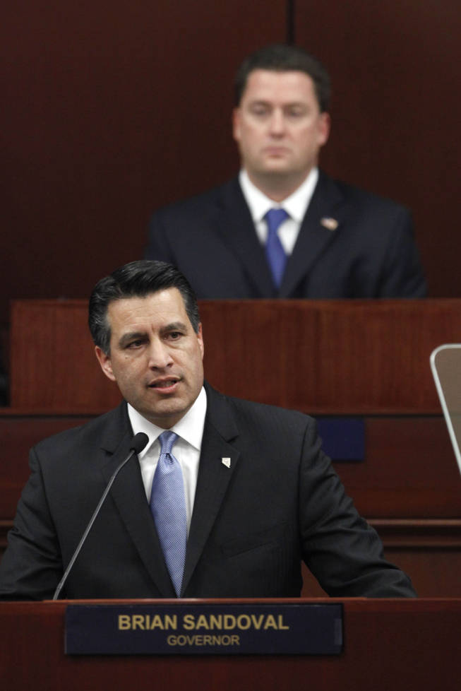 Gov. Brian Sandoval makes his first State of the State address before a joint session of the Nevada Legislature as Assembly Speaker-elect John Oceguera, D-Las Vegas, background, looks on, in Carson City on Monday, Jan. 24, 2011.