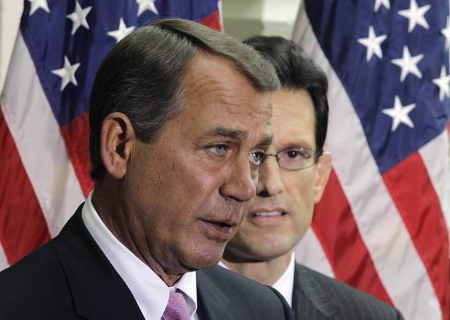 House Speaker John Boehner of Ohio, accompanied by House Majority Leader Eric Cantor of Va., speaks to reporters after their closed GOP caucus meeting ahead of President Barack Obama's State of the Union speech, Tuesday, Jan. 25, 2011, on Capitol Hill in Washington. 