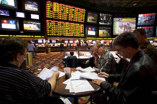 Gamblers consider proposition bets on Super Bowl XLV at the Race and Sports Book in the Las Vegas Hilton Thursday, January 27, 2011. Proposition bets for the Super Bowl were posted on the board at the sports book Thursday afternoon. 