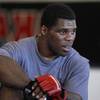 Former NFL football player Herschel Walker looks on while training at American Kickboxing Academy in San Jose, Calif. Walker is scheduled to fight Scott Carson at a Strikeforce mixed martial arts event on Jan. 29.