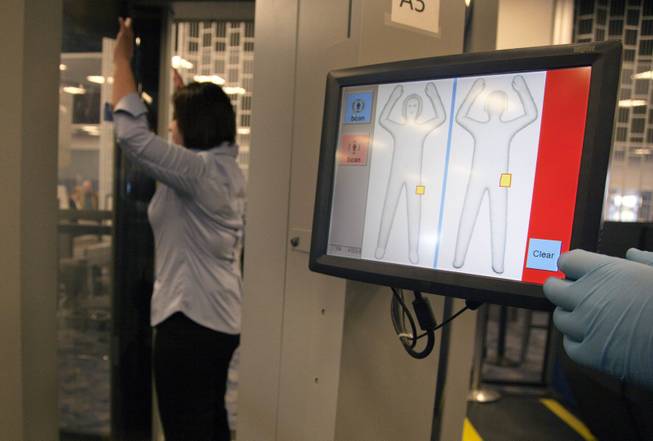 A Transportation Security Administration employee is screened during a demonstration of new software being tested with advanced imaging technology at McCarran International Airport on Tuesday, Feb. 1, 2011. The software will let passengers see what agents see and uses a generic image.