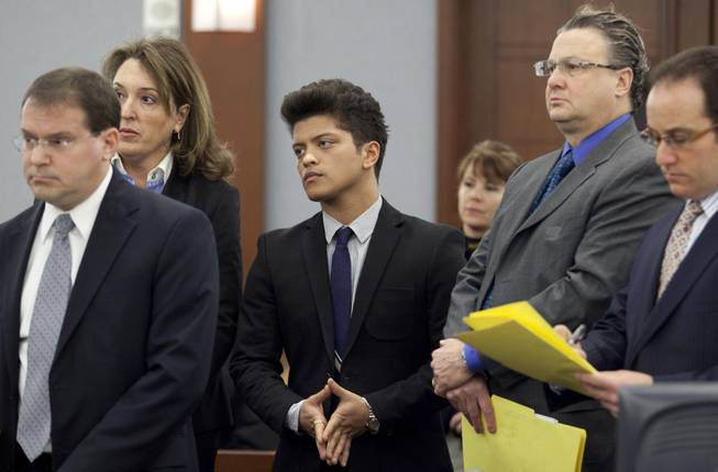 Peter Hernandez, aka Bruno Mars, center, appears in court to waive an evidentiary hearing for a felony cocaine possession charge and receive a date in state court for a plea, Friday, Feb. 4, 2011, in Las Vegas. Mars was accompanied by his defense attorneys Blair Berk, second from left, David Chesnoff, second from right and Richard Schonfeld, right. Deputy district attorney David Schubert, left, looked on. 