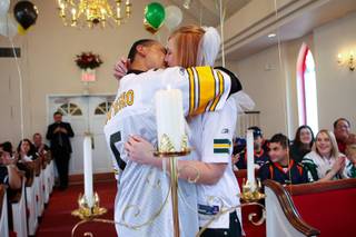 While wearing the jerseys of their favorite teams, Christine McCoy and Claudio Montenegro put aside their competitive energy and join together in a kiss Saturday during their Super Bowl-themed wedding ceremony in Las Vegas.