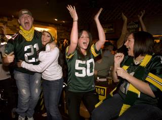Green Bay Packers fans celebrate a touchdown against the Steelers as they watch Super Bowl XLV at the Rum Runner, 1801 E. Tropicana Ave., February 6, 2011. From left are Kyle Drodny, Alicai Williams, Jessica Buscemi, and Samantha Mentzel. 