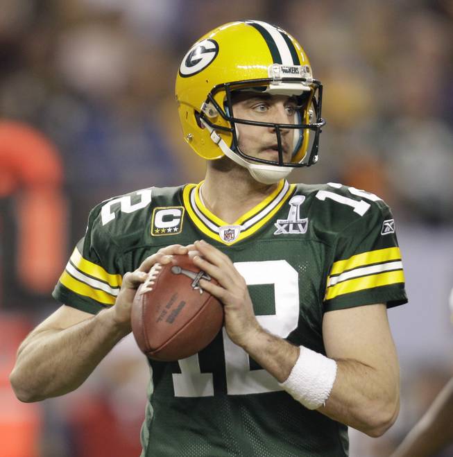 Green Bay Packers' Aaron Rodgers looks to throw a pass during the first half of the NFL football Super Bowl XLV game against the Pittsburgh Steelers on Sunday, Feb. 6, 2011, in Arlington, Texas. 