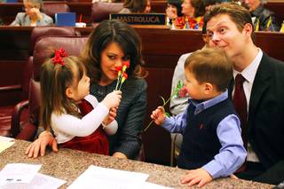 Freshman assemblywoman Teresa Benitez-Thompson and Jeff Thompson's children, Lillian and Eli, play with flowers before the start of the first day of the 2011 legislative session Monday, February 7, 2011 in Carson City.