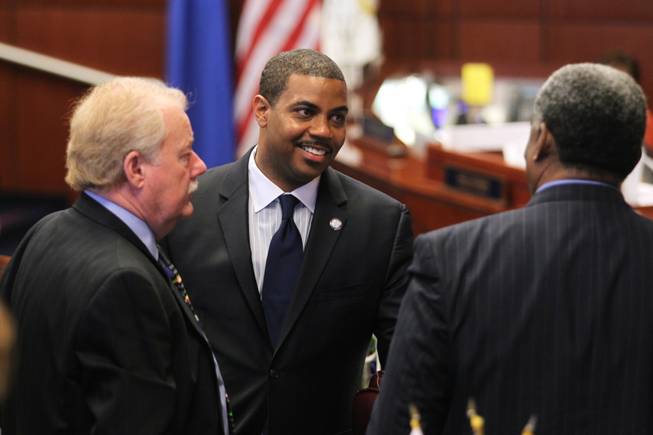 Sens. Mike Schneider, left, and Steven Horsford talk with former Sen. Joe Neal, who was on hand to witness the swearing-in of his daughter, Dina Neal, as an assemblywoman. In a speech, Horsford vowed long-term solutions instead of temporary budget fixes.