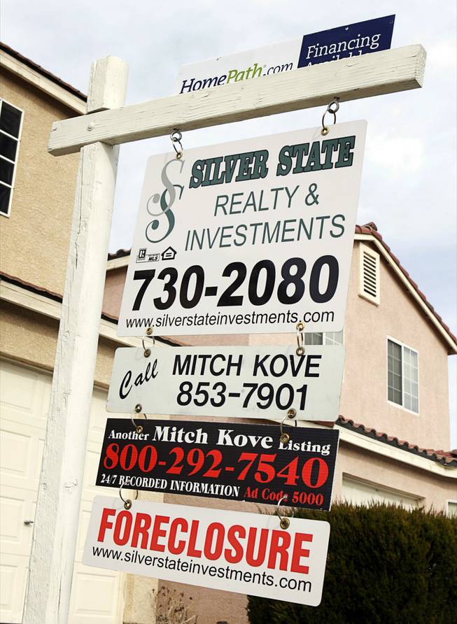 A "for sale" sign is displayed outside a foreclosed home near Hacienda Avenue and Jones Boulevard on Saturday, Feb. 5, 2011.  
