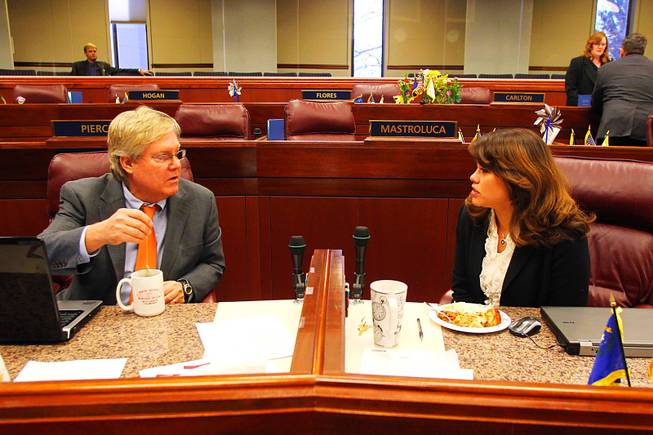 Assembly members Tick Segerblom and Teresa Benitez-Thompson talk before an Assembly meeting on the third day of the 2011 legislative session Wednesday, February 9, 2011 in Carson City.