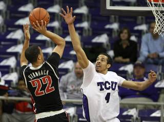Texas Christian's Amric Fields (4) attempts to block a shot by UNLV's Chance Stanback at Daniel-Meyer Coliseum in Fort Worth, Texas on Wednesday, Feb. 9, 2011.