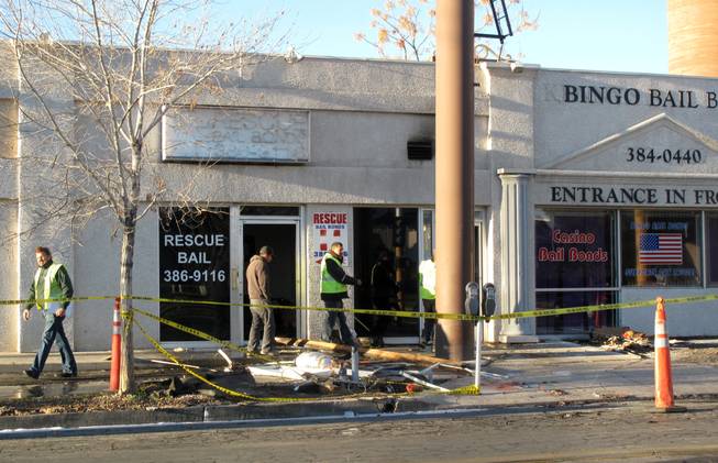 Workers assess damage at a downtown building that houses four businesses. Firefighters responded to a blaze at the building at 2:20 a.m. Feb. 9, 2011. No one was injured, but the building's roof collapsed.