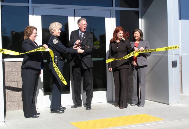 Henderson Mayor Andy Hafen cuts the ceremonial ribbon with Henderson Police Chief Jutta Chambers to unveil the new Henderson Detention Center on Wednesday morning.