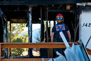 Lt. Steve Moody of Pahrump Valley Fire and Rescue inspects a house at 3421 Prospector Lane, Pahrump, after a fire that left one adult and three children dead on Wednesday, Feb. 9, 2011.