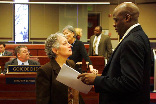 Assembly members Peggy Pierce and Kelvin Atkinson talk before a meeting of the Assembly on the third day of the 2011 legislative session Wednesday, February 9, 2011 in Carson City.