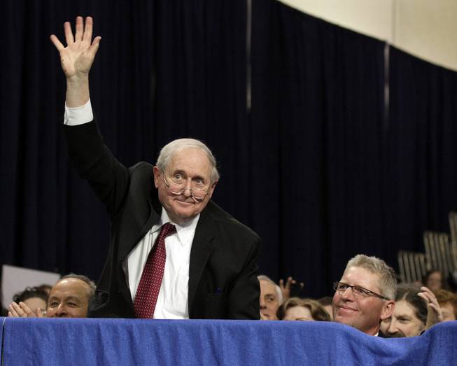 Sen. Carl Levin, D-Mich., waves as he is acknowledged by President Barack Obama at Northern Michigan University, Thursday, Feb. 10, 2011, in Marquette, Mich. Seated at right is Marquette, Mich., Mayor John Kivela.  (AP Photo/Carolyn Kaster)