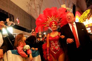 Las Vegas Mayor, Oscar Goodman, stands with a showgirl during the opening ceremonies for the 2011 USA Sevens International Rugby Tournament Thursday, February 10, 2011 at the Fremont Street Experience in Las Vegas.