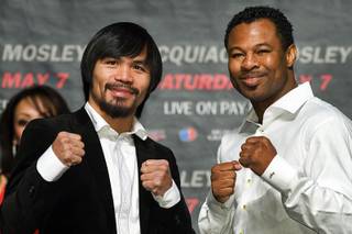 Boxers Manny Pacquiao of the Philippines and Shane Mosley of Pomona, Calif. pose during a news conference at the MGM Grand Garden Arena Saturday, February 12, 2011. The fighters are promoting their May 7 welterweight fight at the arena. 