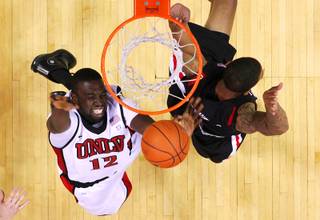 UNLV forward Brice Massamba puts up a shot against San Diego State forward Malcolm Thomas during their game Saturday, February 12, 2011 at the Thomas & Mack Center. San Diego State won 63-57.