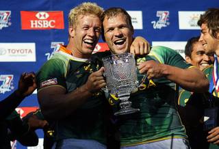 South African players Kyle Brown, left, (#6) and Frankie Horne (#3) celebrate after beating Fiji during the final match of the 2011 USA Sevens Rugby World Series at Sam Boyd Stadium Sunday, February 13, 2011.