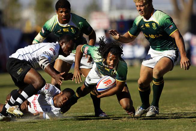 Cecil Afrika of South Africa is tackled during the final match of the 2011 USA Sevens Rugby World Series at Sam Boyd Stadium Sunday, February 13, 2011. South Africa beat Fiji for the championship 24-14.