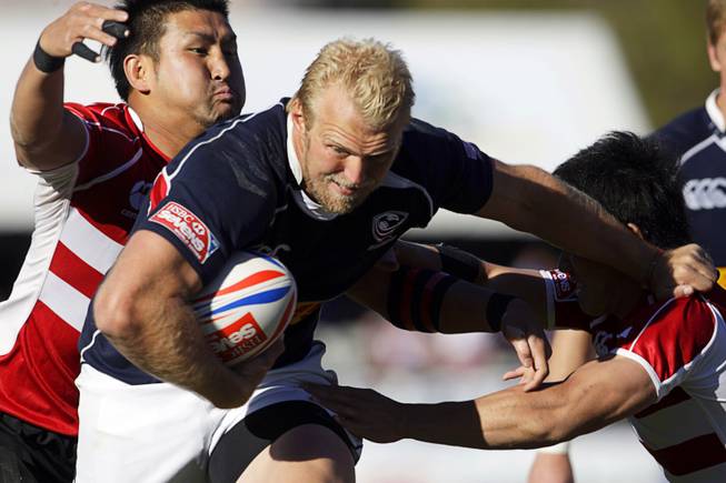 Matt Hawkins of the USA Eagles muscles his way through Japanese defenders during the 2011 USA Sevens Rugby World Series at Sam Boyd Stadium on Sunday, Feb. 13, 2011. The USA Eagles won 27-7 over Uruguay, then beat Japan 19-12 to win the Shield final.