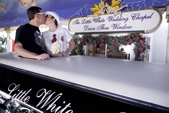 Richard, left, and Lisa Dishong, of Harrisburg, Penn., kiss while waiting to be married at the drive thru window of the Little White Wedding Chapel, Monday, Feb. 14, 2011 in Las Vegas. 