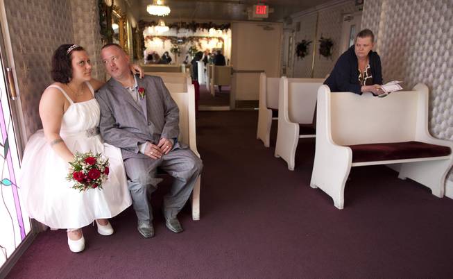 Amanda, left, and Albert Burton wait for receive their marriage certificate as Mona Burton, Albert's mother, looks on after the two married at the Little White Wedding Chapel, Monday, Feb. 14, 2011 in Las Vegas. 