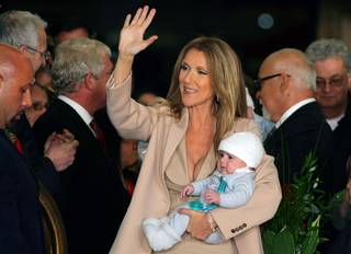 Celine Dion holds her son Nelson as she waves to employees, reporters and fans after arriving at Caesars Palace with her husband and sons in Las Vegas on Feb. 16, 2011. The singer begins a new series of shows at The Colosseum at Caesars Palace on March 15.