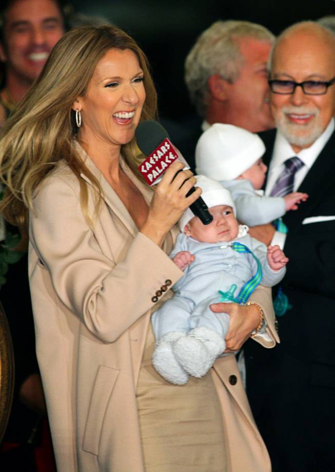 Celine Dion speaks to employees, reporters and fans as she arrives at Caesars Palace with her husband and sons on Feb. 16, 2011. Dion is holding her son Nelson. Her husband Rene Angelil is holding twin brother Eddy. The singer begins a new series of shows at The Colosseum at Caesars Palace on March 15.