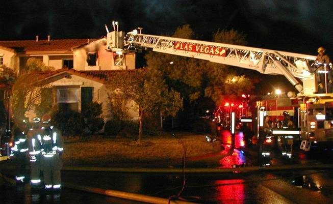 Las Vegas firefighters battle a blaze Saturday morning at a northwest valley home. Authorities say a homeless person had been staying at the home and the cause of the fire is under investigation. 