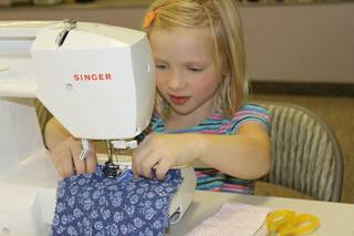 Georgia Deibert, 6, perfects her sewing skills during a class at Little Hip Chix Studio.