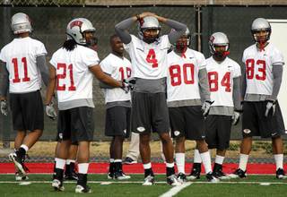 Wide receiver Phillip Payne (#4), center, a graduate of Western High School, works out with the UNLV Rebels on the first day of Spring football practice at Rebel Field Monday, February 28, 2011.