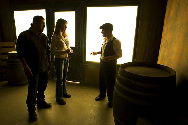 A prohibition-era "gangster" gives instructions to Sergio Tamez, left, and Candice Rodriguez in the back of a speakeasy during a preview of the Las Vegas Mob Experience at the Tropicana Tuesday, March 1, 2011. The $25 million Mob Experience will officially open March 29.
