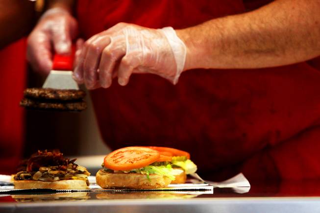Burgers are dished up on opening day at Five Guys Burgers and Fries in Henderson, which opened Wednesday, March 2, 2011, on Eastern Avenue.