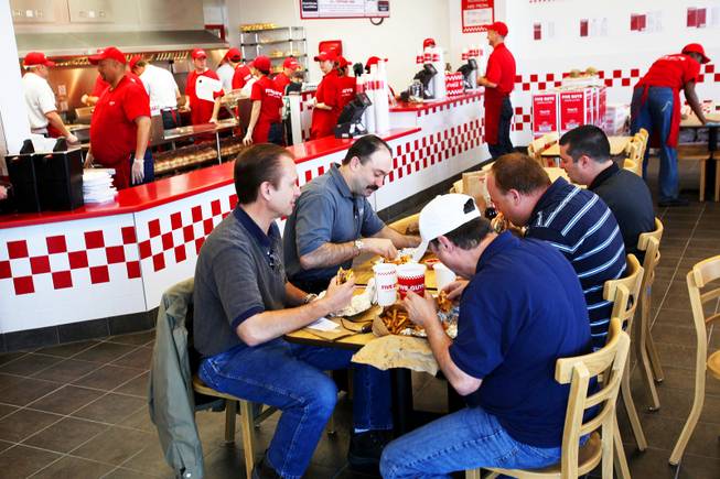 Customers -- incidentally "five guys" -- dine at the new Five Guys Burgers and Fries location on Eastern Avenue in Henderson on Wednesday, March 2, 2011.