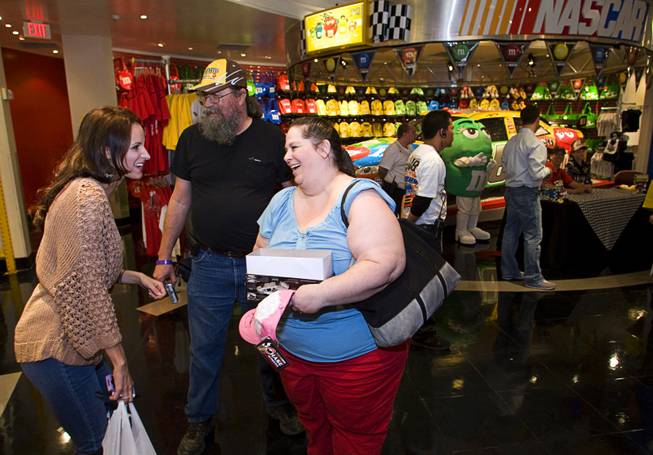 Lisa Knefelkamp and her husband Craig chat with Samantha Busch, wife of NASCAR driver Kyle Busch, at the M&M's World Las Vegas store on the Las Vegas Strip Thursday, March 3, 2011. Knefelkamp brought homemade cookies and BBQ sauce for the Busch's.