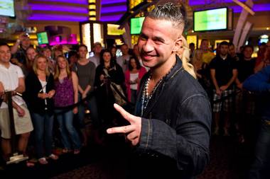 Holly Madison interviews Mike “The Situation” Sorrentino for Extra at the 2011 Nightclub & Bar Convention on March 8, 2011.