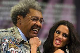 Boxing promoter Don King poses with Tecate Girl Janice KakIsh during a news conference at the MGM Grand Wednesday, March 9, 2011.