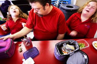 College of Southern Nevada student Terry Spieker eats lunch with his autistic daughters Jillie, left, 7, and Lexie, 9, at the Bridge Program at Cumorah Academy, a special program for autistic children that opened last year. The school's opening has allowed Terry the time to go back to school for nursing.