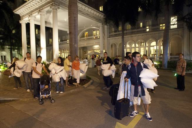 Hotel guests from the Moana Surfrider evacuate early Friday, March 11, 2011 in Honolulu. The state of Hawaii is under a tsunami warning due to a large 8.9 earthquake which struck off Japan. The earthquake is believed to have generated a tsunami wave. The Pacific Tsunami Center expects the wave to hit Oahu at 3:21 a.m. Hawaiian Standard Time.