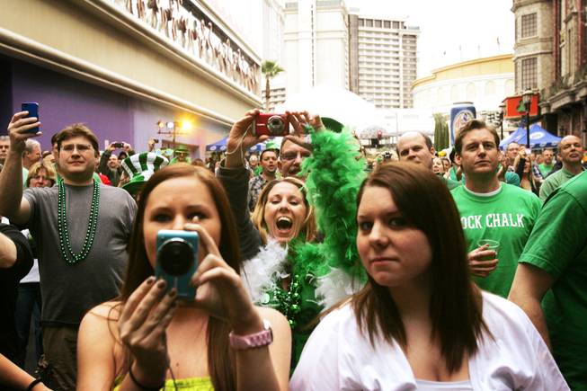 A fan cheers for Holly Madison as she is announced for her beer pong rematch against Brian Thomas, a.k.a. Lucky the Leprechaun outside O'Sheas in Las Vegas during St. Patrick's Day Thursday, March 17, 2011.
