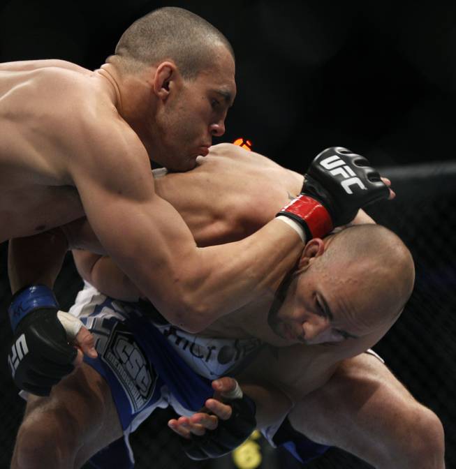 Luiz Cane, left, takes down Eliot Marshall during their mixed martial arts match at UFC 128  Saturday, March 19, 2011, in Newark, N.J. Cane won by TKO in the first round.