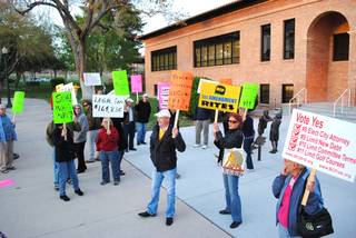 Protesters gather in front of Boulder City Hall on Tuesday to demonstrate against the city's decision to sue the petitioners of two ballot questions that passed in November. 