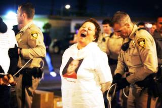 A woman is taken into custody by Metro Police after a nonviolent sit-in on Teddy Drive outside of Palace Station following a march by Culinary Union Local 226 members from their headquarters to Palace Station as a statement against Station Casinos' treatment of Latino workers on Thursday, March 24, 2011.