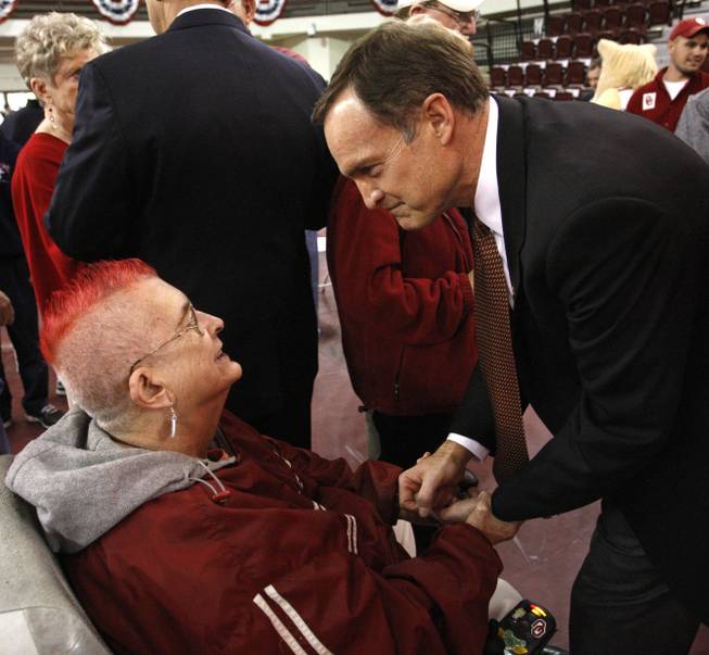 Lon Kruger greets Oklahoma fan and employee Carolyn Powell, left, following his introduction as men's head basketball coach in Norman, Okla., Monday, April 4, 2011. 