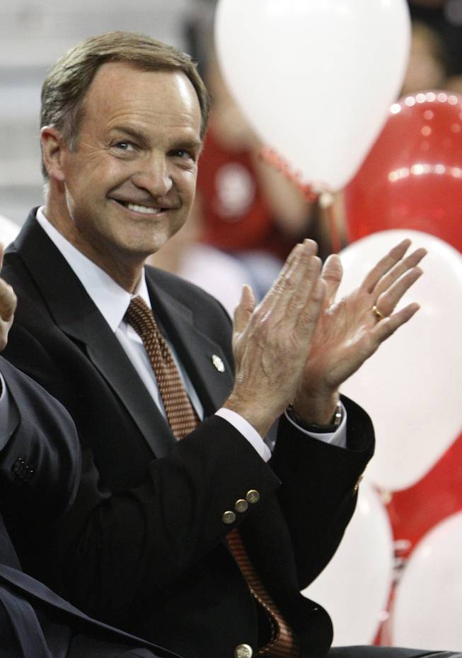 Newly named Oklahoma basketball coach Lon Kruger applauds as his wife, Barbara, not in photo, is introduced in Norman, Okla., Monday, April 4, 2011. 
