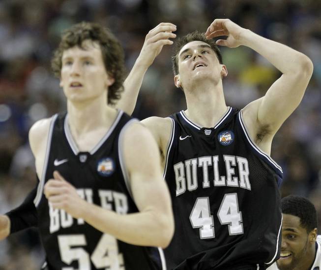 Butler's Andrew Smith (44) reacts in front of teammate Matt Howard during the second half of the men's NCAA Final Four college basketball championship game against Connecticut Monday, April 4, 2011, in Houston. 